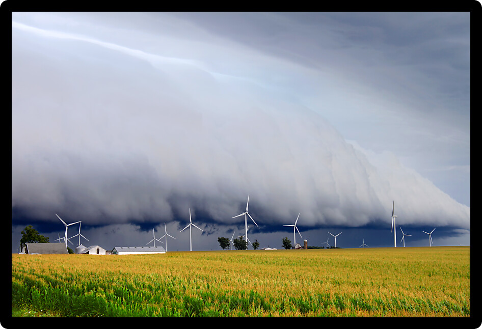 Wind turbines under a dark and ominous shelf cloud in northern Illinois.
