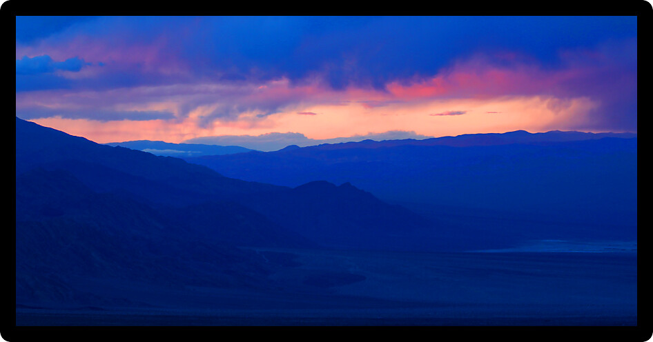 Sunset over the vast open landscape of Death Valley in California.