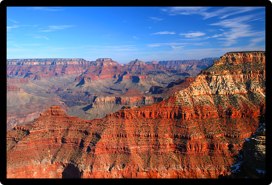 Jagged rocky mountains rise steepy from the floor of the Grand Canyon in Arizona.
