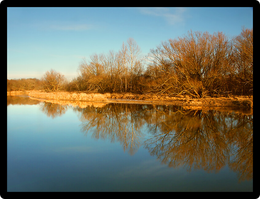 Kishwaukee River under evening sunlight in Illinois.