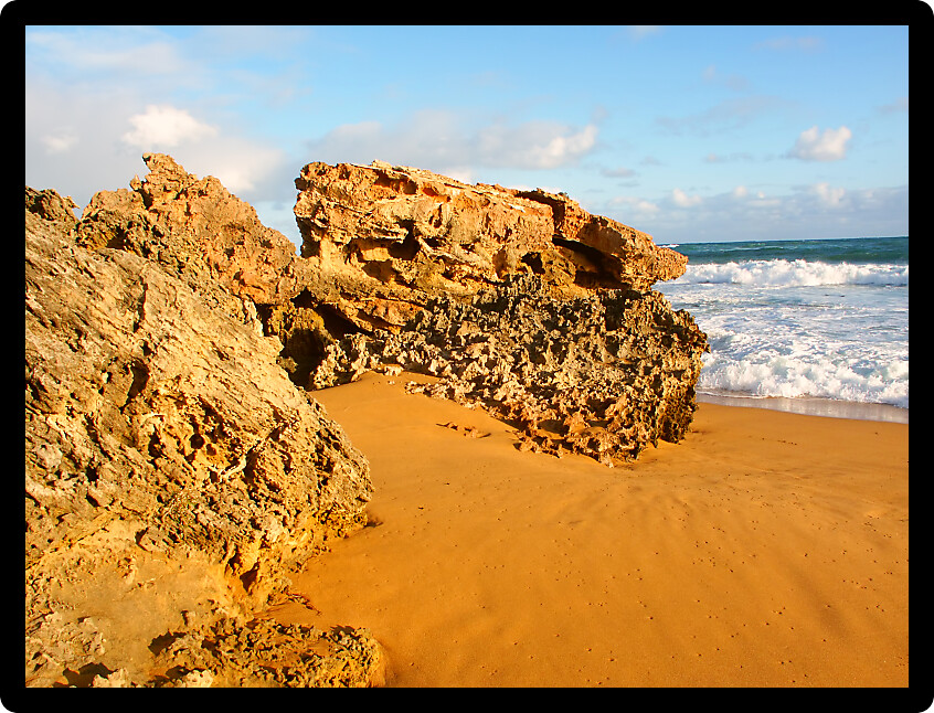 Rugged rocks jut out of the beach along the southern coast of Victoria Australia.