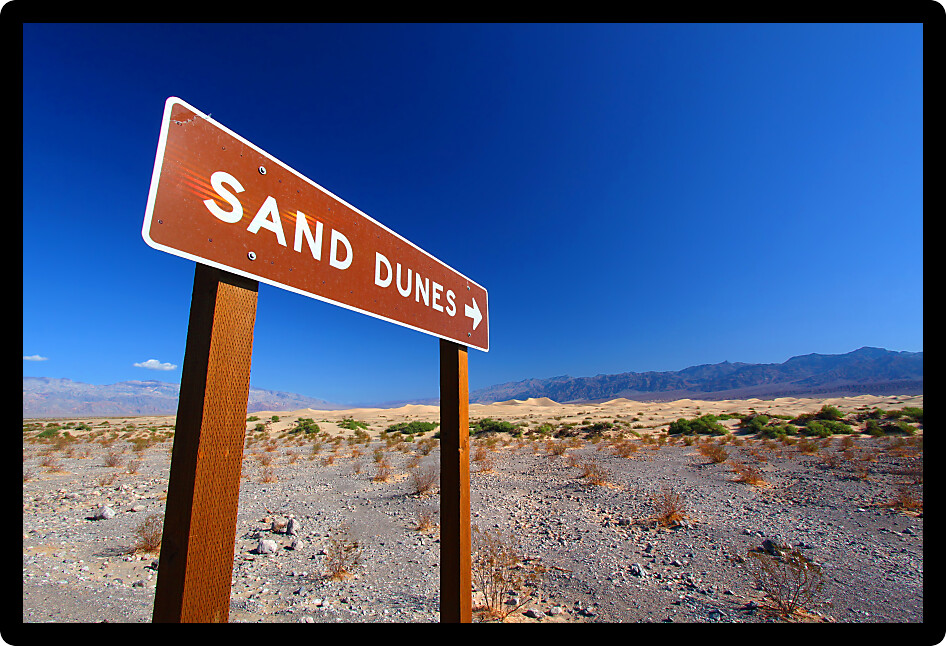 Sign in Death Valley National Park pointing out location of the Mesquite Flat Sand Dunes for visitors.