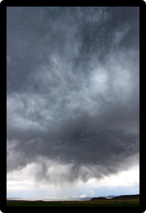 Dark clouds and precipitation from a thunderstorm in rural Idaho.