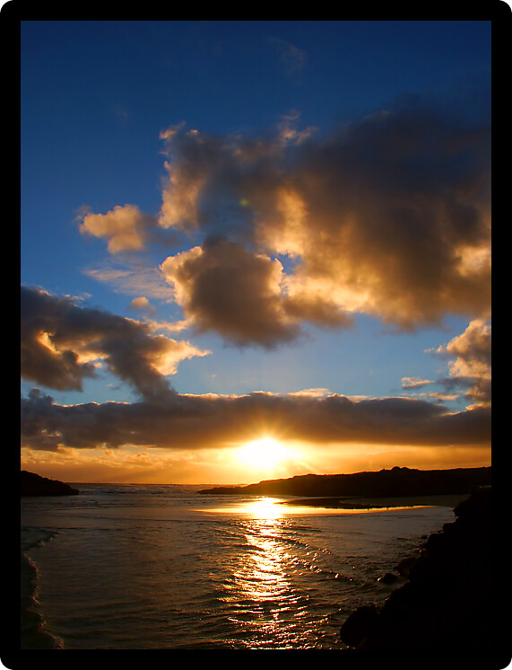 Small waves at sunset where the Merri River empties into the sea at Warrnambool in Australia.