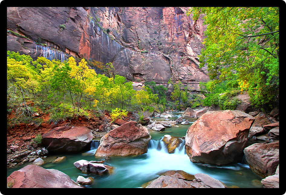 Waterfall on the Virgin River flows through large boulders in Zion Canyon.